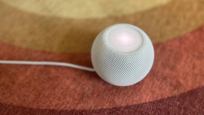 A HomePod Mini on the floor