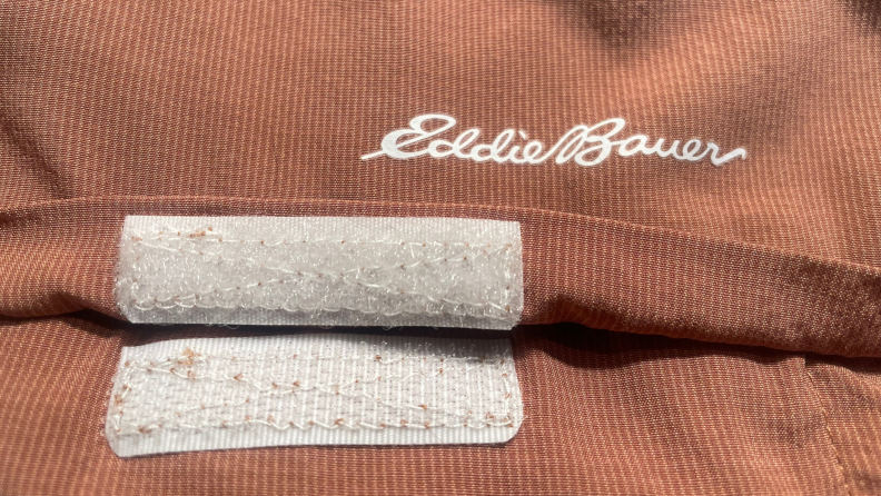 A close-up of a women's orange, Eddie Bauer shirt.