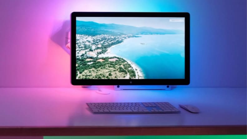 A home office lit by colorful LED lights.