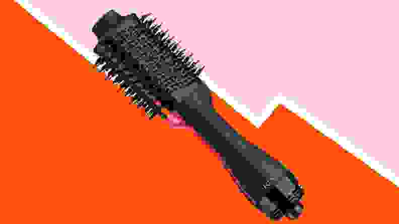 Hairdryer brush on red and pink background