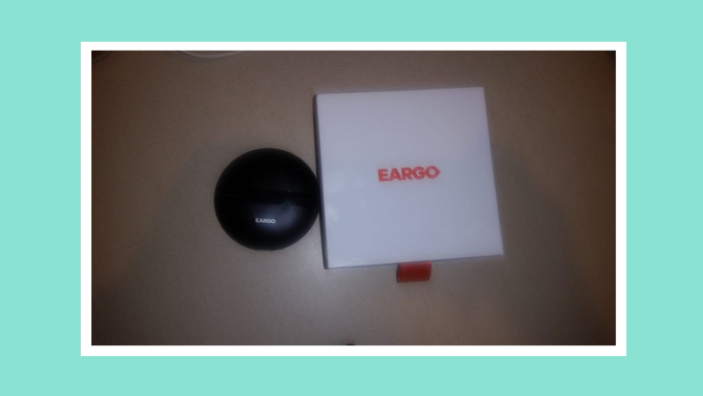 Box packaging for the Eargo 6 hearing aids next to the charging case.