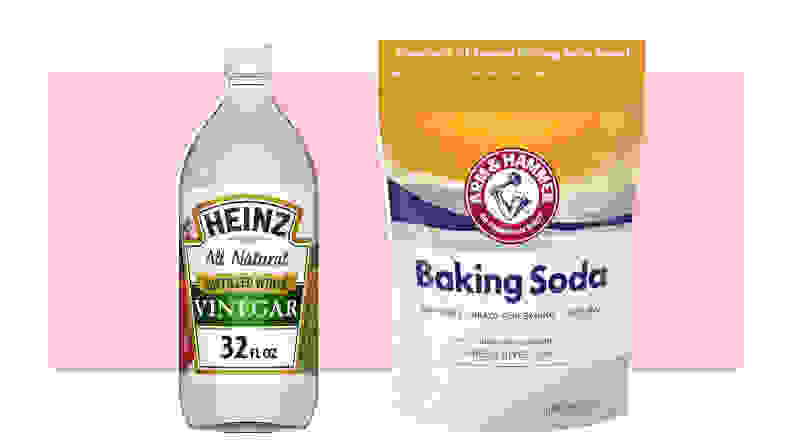 A bottle of Heinz vinegar and a packet of Arm & Hammer baking soda.
