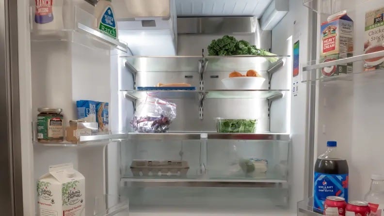 The The best three-door French-door refrigerator, the Bosch B36CD50SNS with its doors open showing food on the shelves and doors.