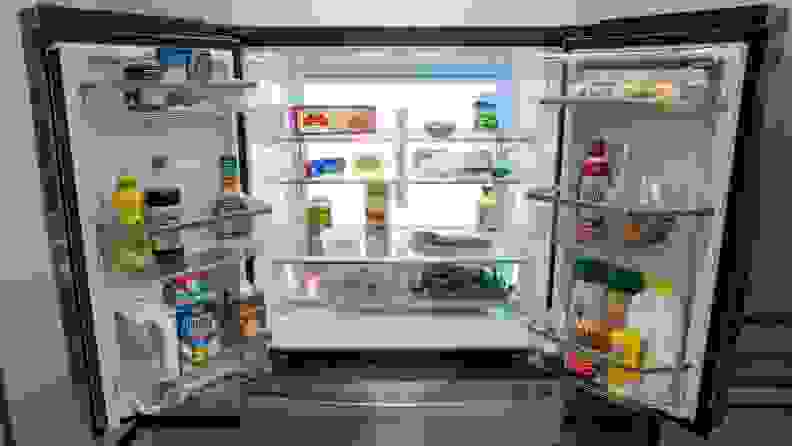 A shot of the interior of the fridge, each shelf and bin stacked with items, all illuminated by the LED backlight.