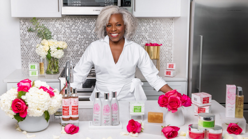 Woman sitting at a table with cosmetics