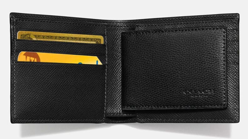 The inside of an opened black Coach wallet.