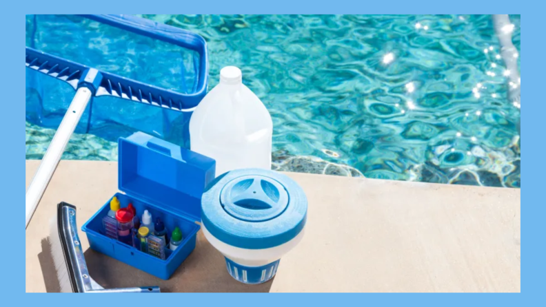 A top-down shot of a pool, with a man kneeling on the ground above the water using a hand skimmer. To his side, at the bottom of the pool, an automatic cleaner is picking up debris.