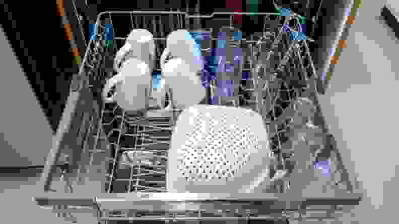 Glasses, cups and strainer sitting on top rack of LG LDTH7972S dishwasher.