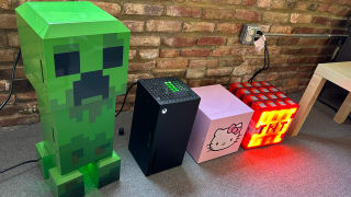 n array of novelty thermoelectric coolers set up to test in our office. They are, from left to right, a cooler in the shape of the Creeper enemy from Minecraft, an XBox, a small cube-shaped cooler with Hello Kitty's face on the front, and a cooler with the shape and design of a Minecraft TNT block.
