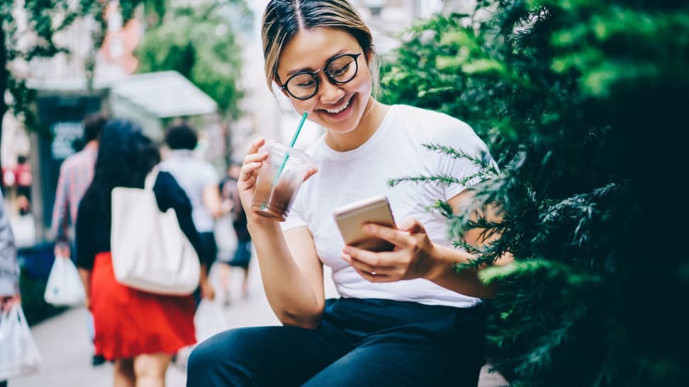 A woman checking her Varo bank mobile app