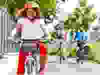 Girl with on a bike wearing a red helmet