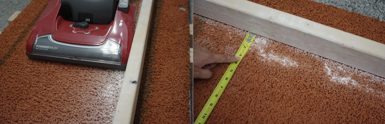 Talcum powder is vacuumed up along a model of a corner baseboard.