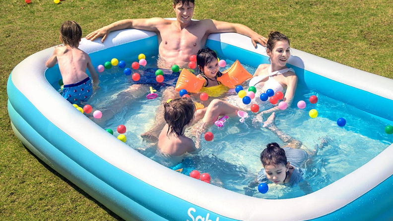 A family sitting in a large Sable pool