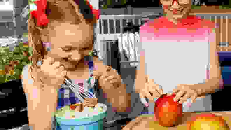 Two children happily cooking