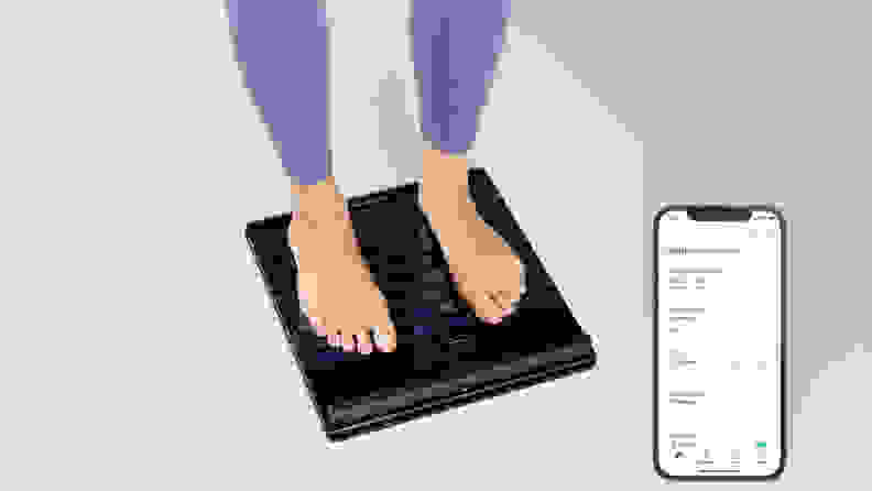 A woman standing on the Withings Body Scan.