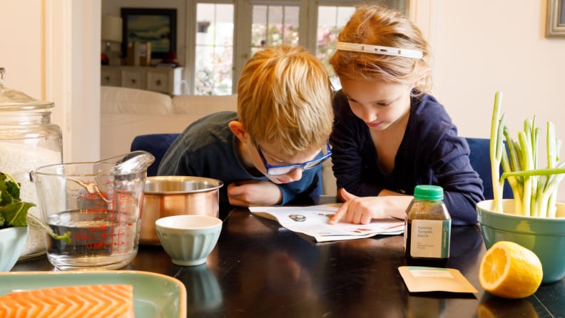 Boy and girl reading recipe.