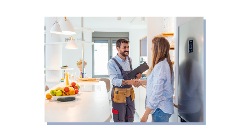 Homeowner shaking hands with contractor indoors.