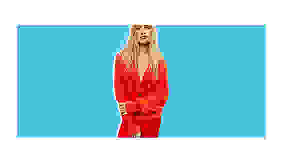 A model wearing a red cardigan.