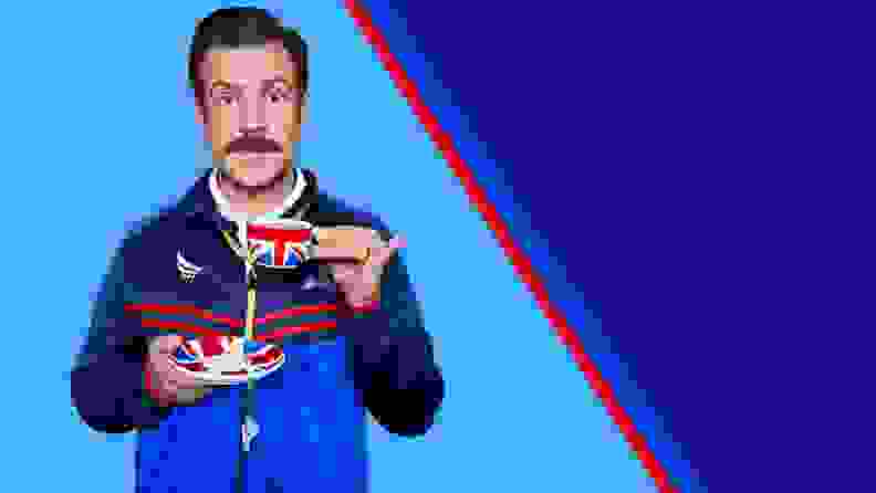 The character Ted Lasso holding a Union Jack teacup against a light blue background split in half with a red line with a dark blue background.