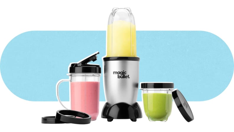 The Magic Bullet Blender in the middle of two included cups and their lids, with smoothies inside.