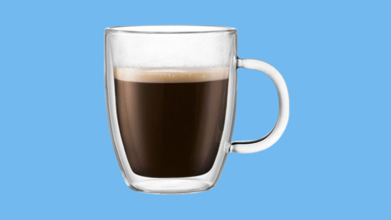 Filled coffee mug against blue background