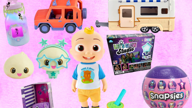 Assorted children's toys in front of pink background.