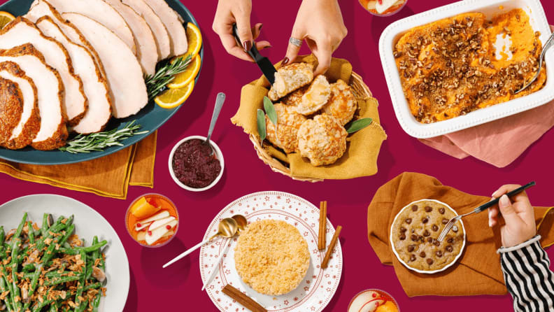 A spread of Thanksgiving dishes on a red table, shot from above