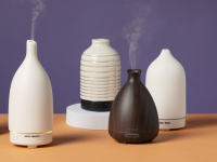 Five oil diffusers sitting on a table.