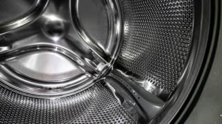 A close-up detail of a stainless steel washing machine drum