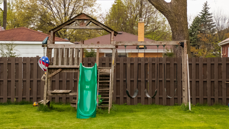 Vacant children's play structure in backyard.