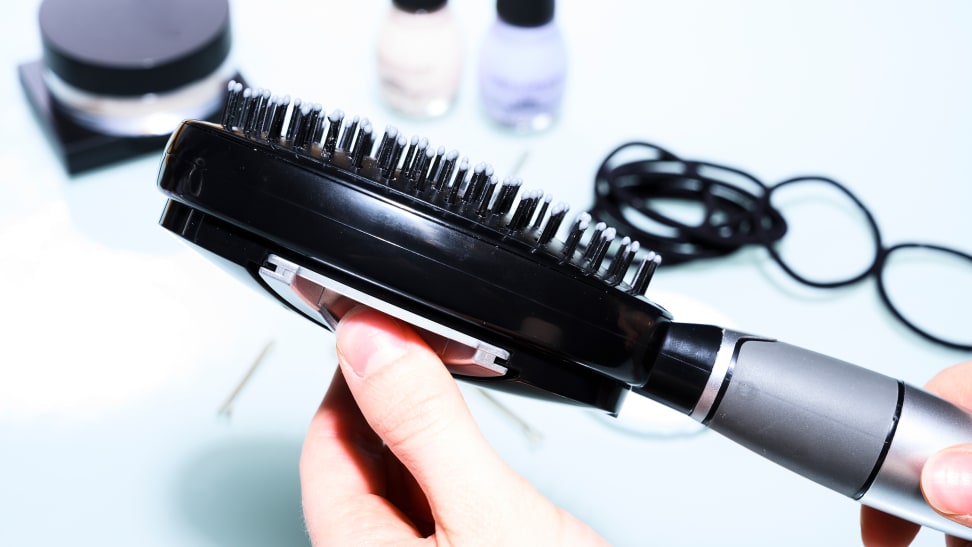 The Qwik-Clean Self-Cleaning Hair Brush buttons