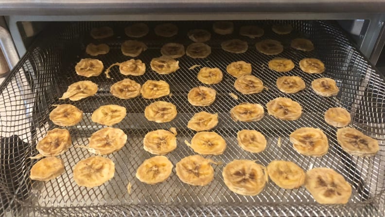 A tray of banana chips comes out of the Ninja Foodi oven.