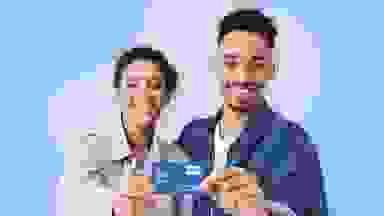 A man and a woman hold a Tello Mobile phone card