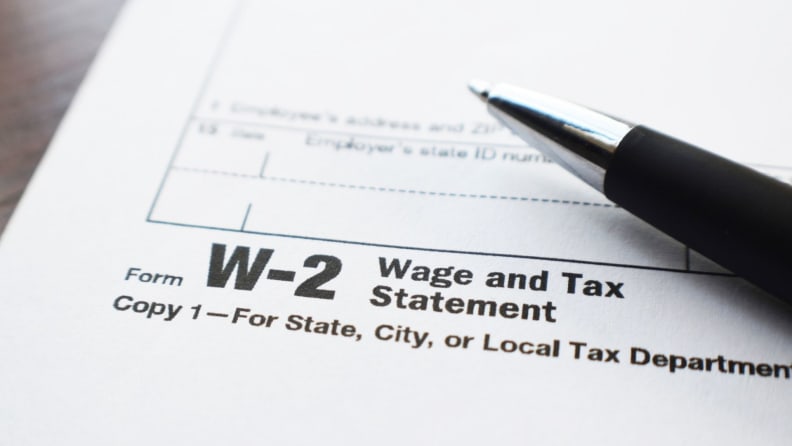 A closeup image of a pen on top of a W-2 wage and tax statement