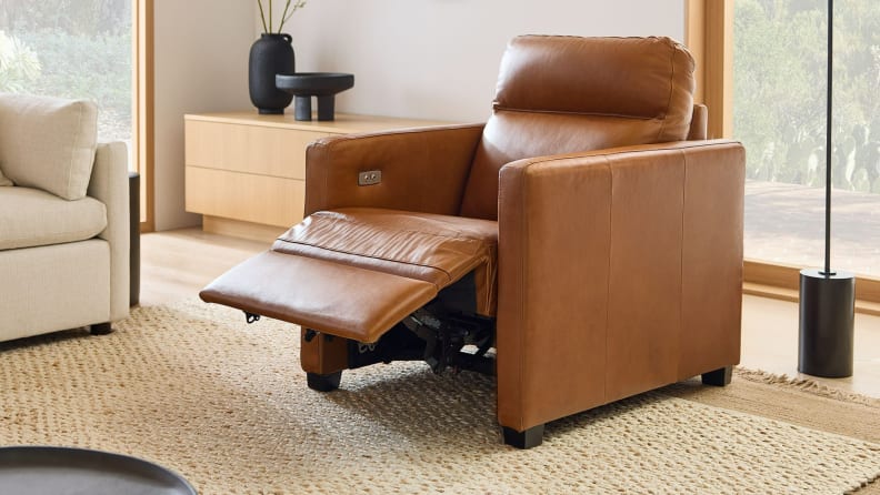 A brown Harris Leather Power Recliner by West Elm reclined in living room setting