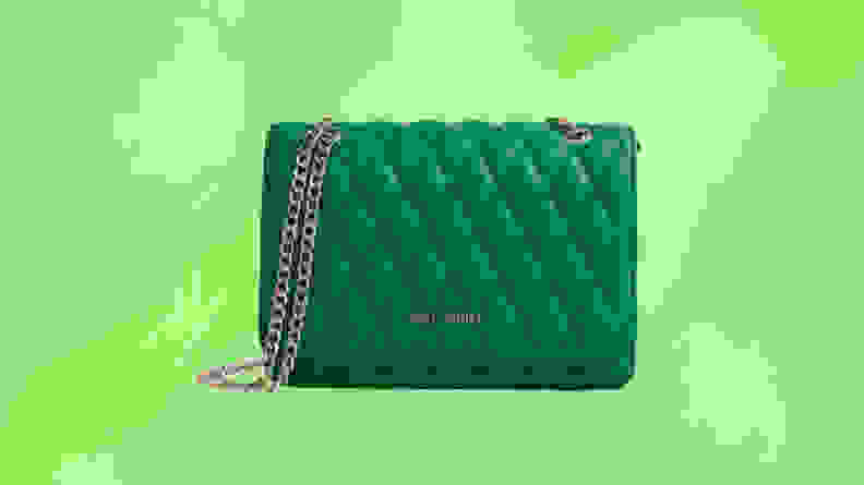 A green crossbody bag in front of a green background.