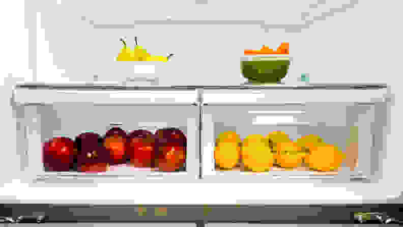 A close-up of the Frigidaire FFBN1721TV French door refrigerator's crisper drawers, with some colorful fruit in them for scale.