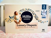 Millie Moon luxury diapers box inside a crib.