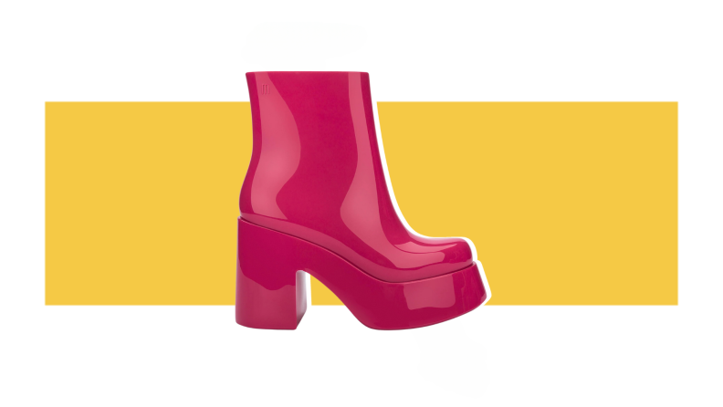 Bright pink, tall boot against a yellow background