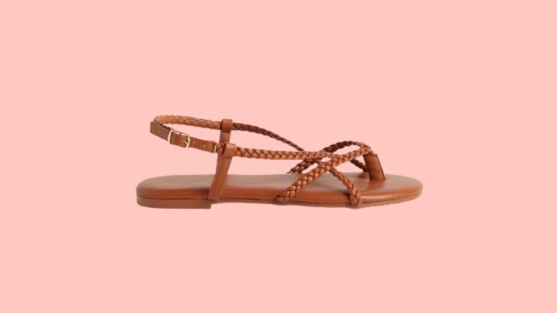 Flat brown leather gladiator sandals with braided straps.