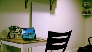 The Kelvin space heater hangs on a wall near a desk