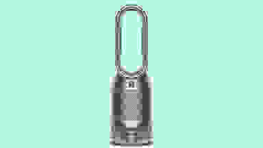 Close up of a Dyson air purifier against a green background.