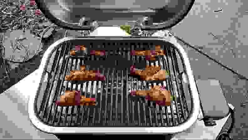 Chicken drumsticks being grilled on the Weber Lumin.