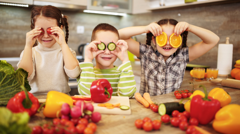 Three kids playing with their food