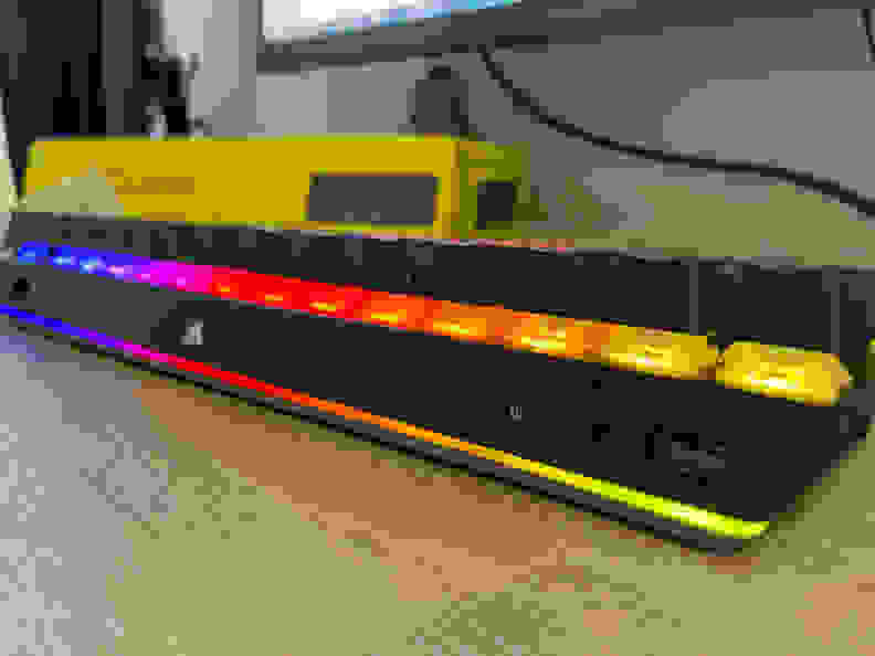 An angled view of a black keyboard highlighting its RGB lighting.