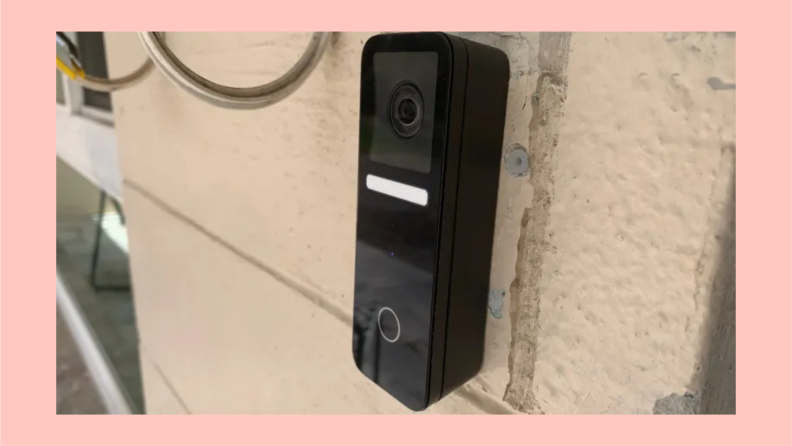 The Logitech Circle View Doorbell hangs on a home.