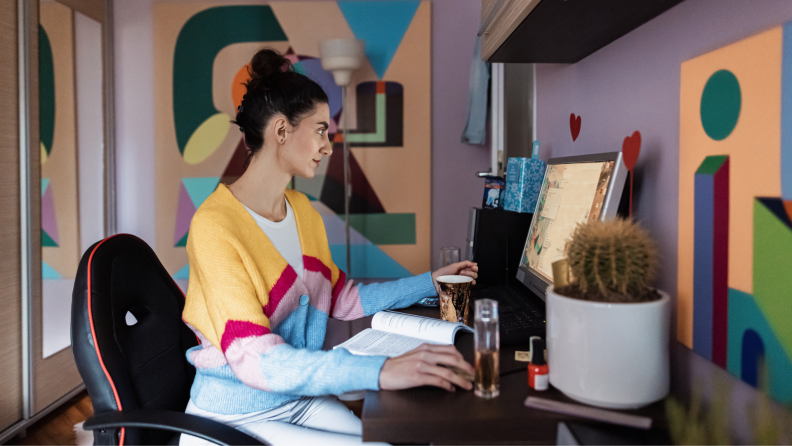 Person working at desk in colorful office space.