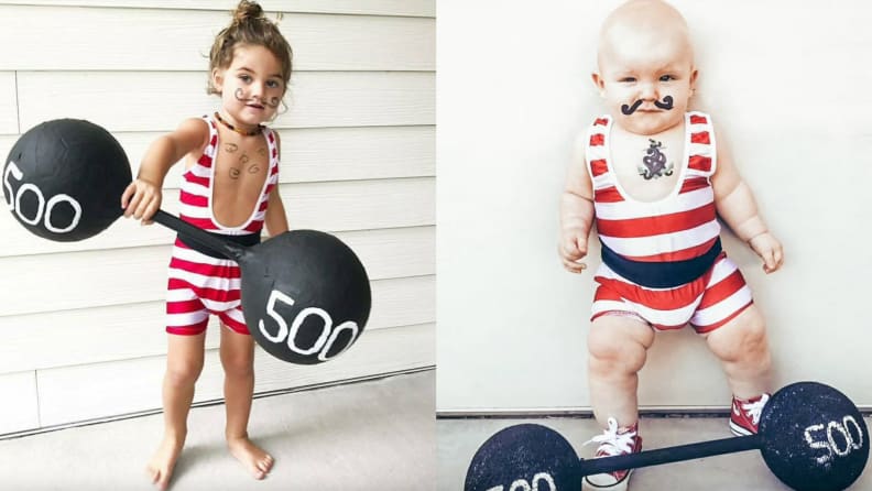 Children dressed up in strong man costume while holding barbell prop.