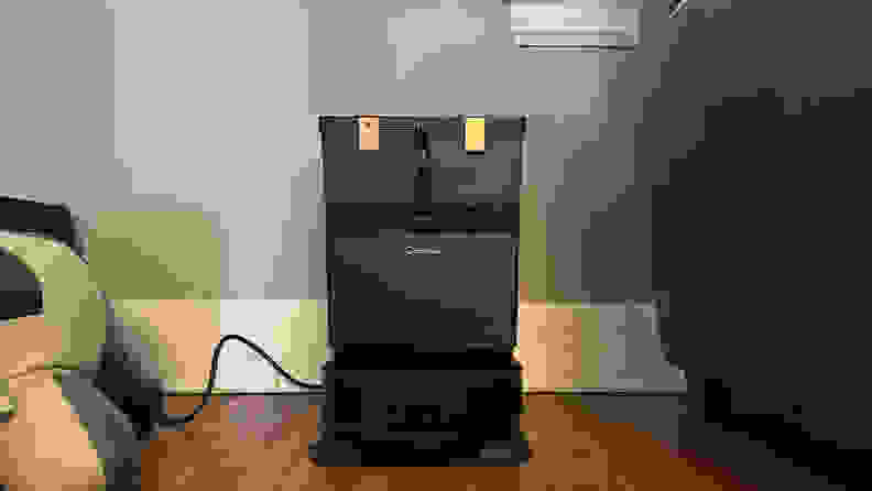 A black robot vacuum at its dock station