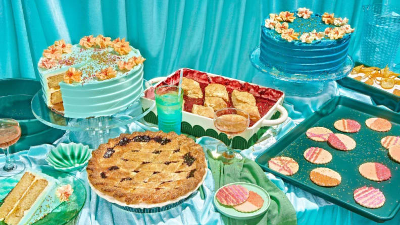 A colorful blue-hued tablescape featuring various pieces of ceramic bakeware by the brand Great Jones.